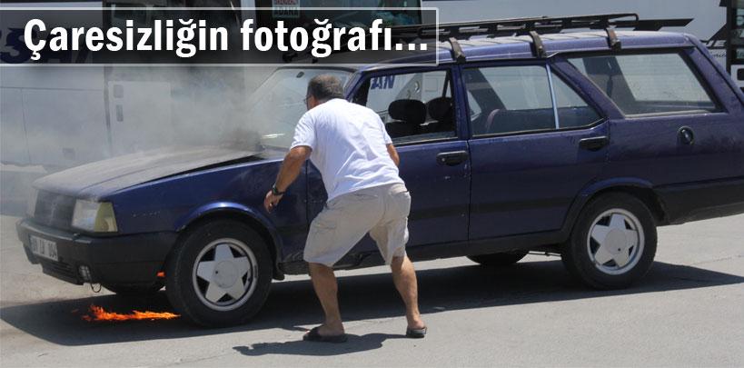 Yanan otomobilini üfleyerek söndürmeye çalıştı